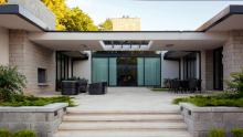 Back courtyard of residence with steps down to pool area.